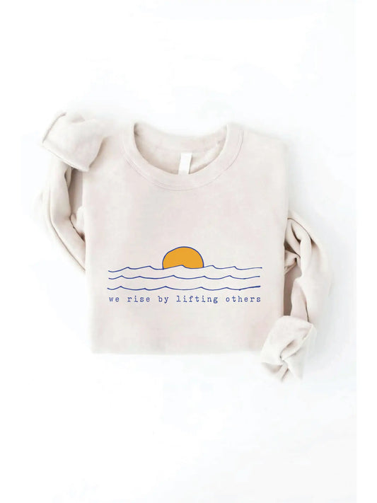 Beige sweatshirt with a sunset and text design on a white background